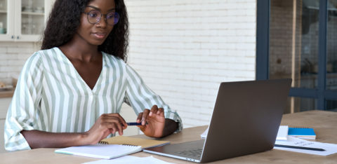 woman researching common tax types on her laptop