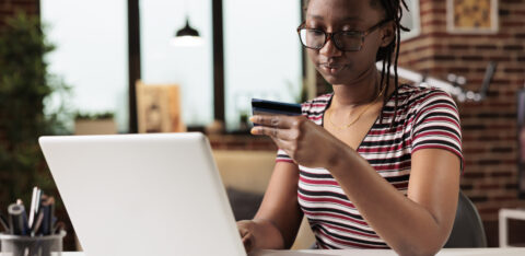 woman holding credit card making payment