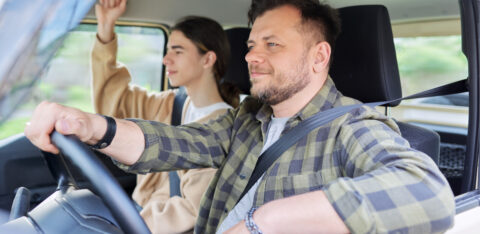 father driving with teenage son