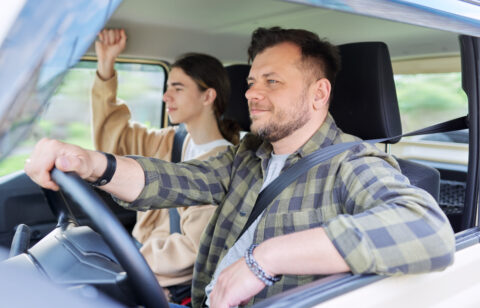 father driving with teenage son