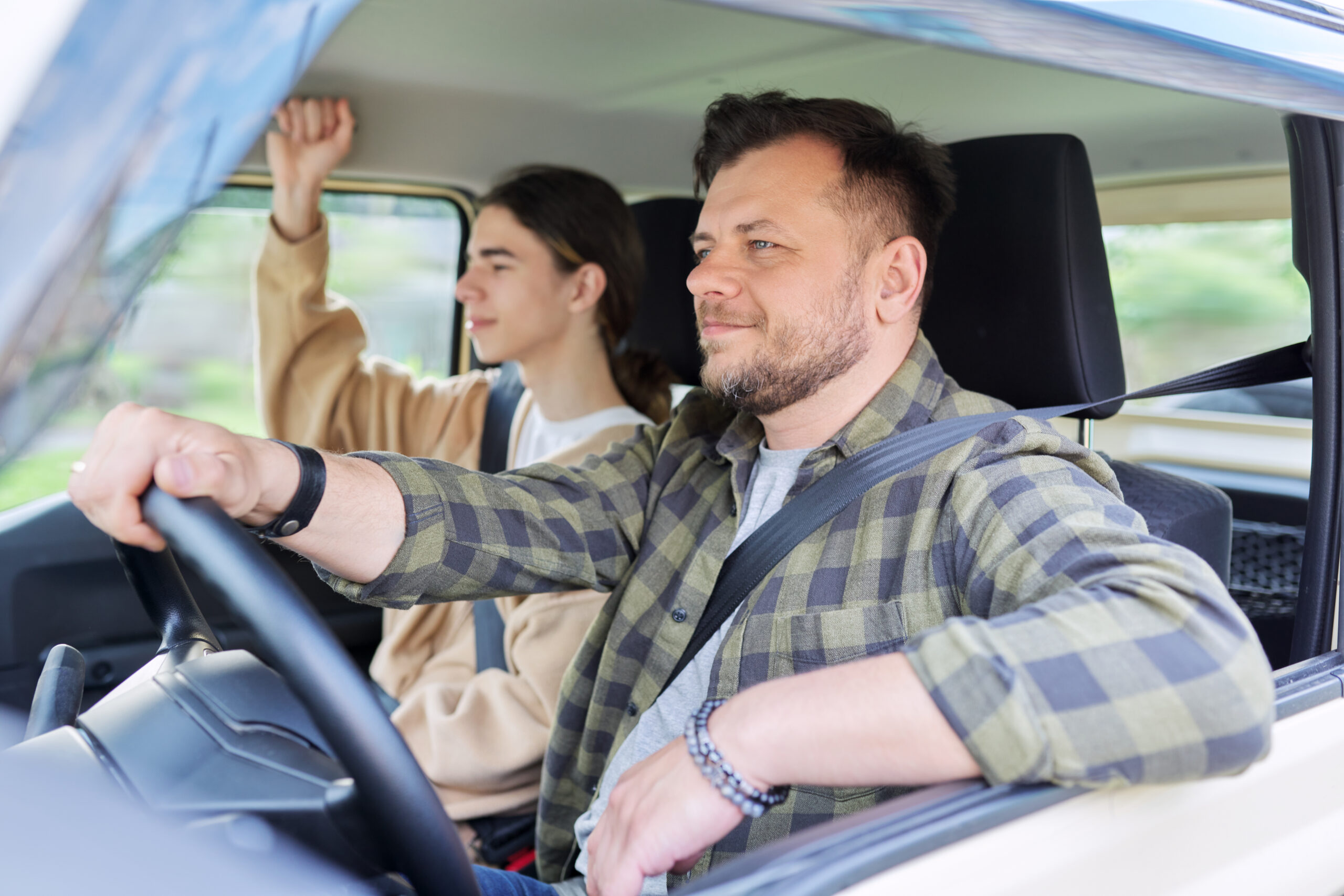 father driving with teenage son