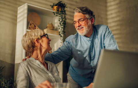 Senior couple researching 401k vs Roth IRA