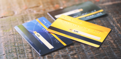 Several credit cards on wooden table