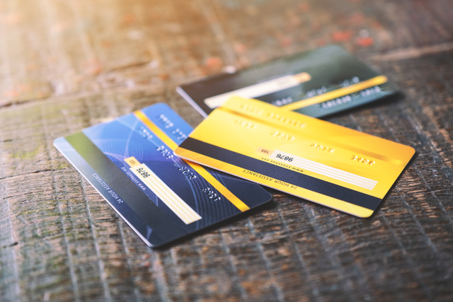 Several credit cards on wooden table