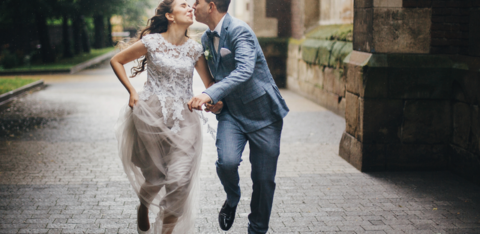 beautiful happy wedding couple smiling and kissing