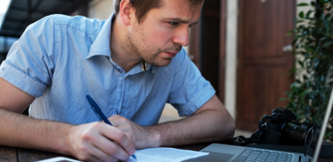 man makes a business plan on his computer