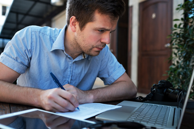 man makes a business plan on his computer