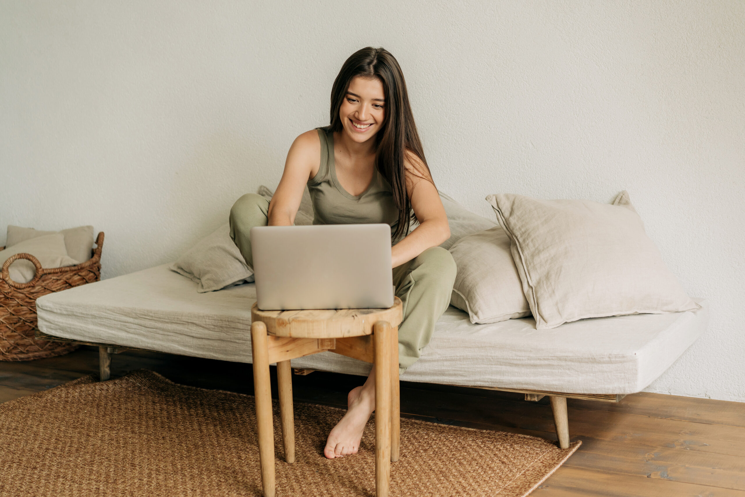 Young happy woman is working at home on a laptop.