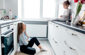 SIngle Woman sitting down in kitchen