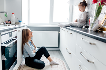 SIngle Woman sitting down in kitchen