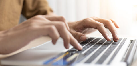 Hands Typing On A Computer With Credit Card