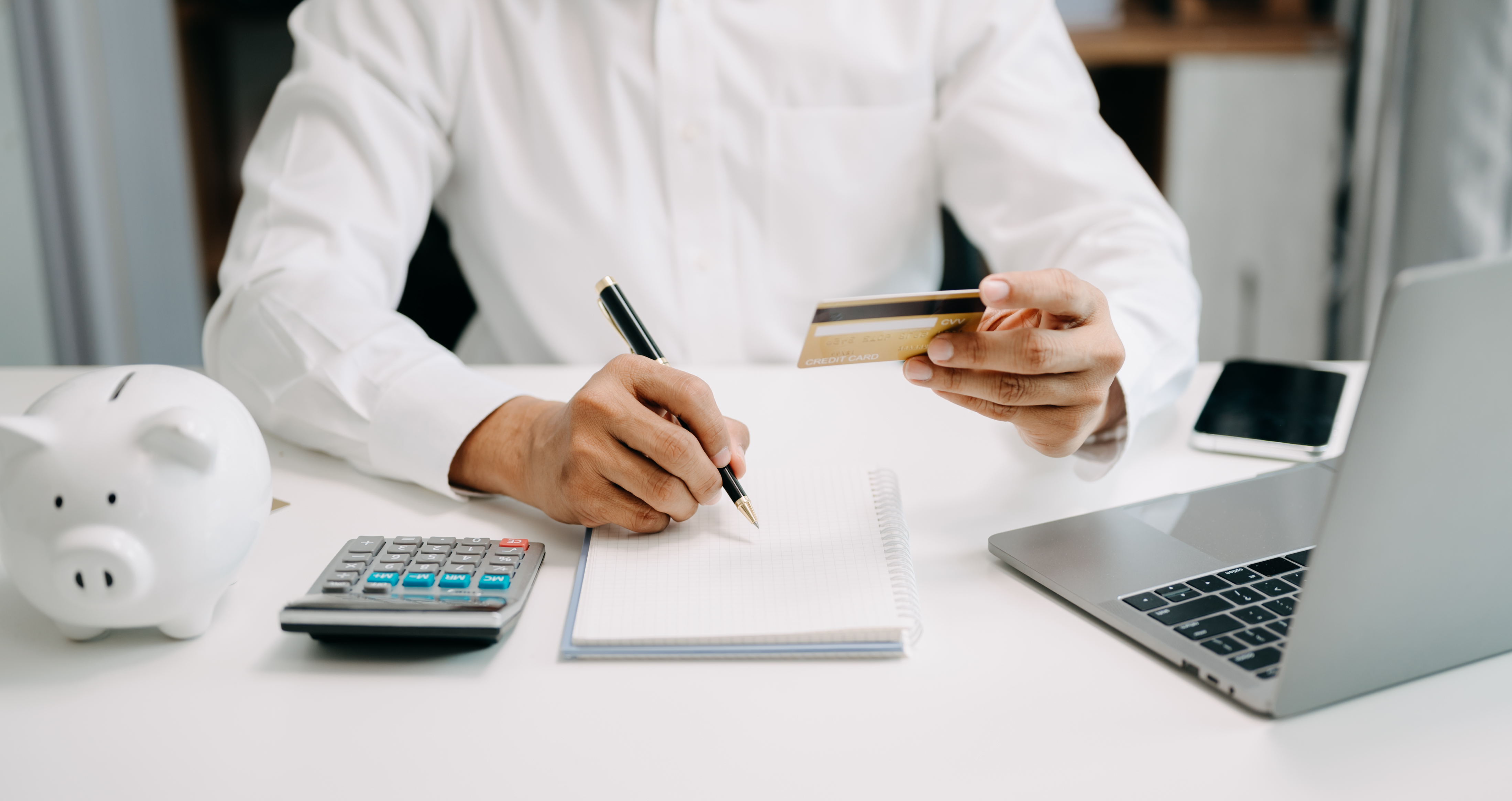 Businessman using calculator with credit card for shopping inter