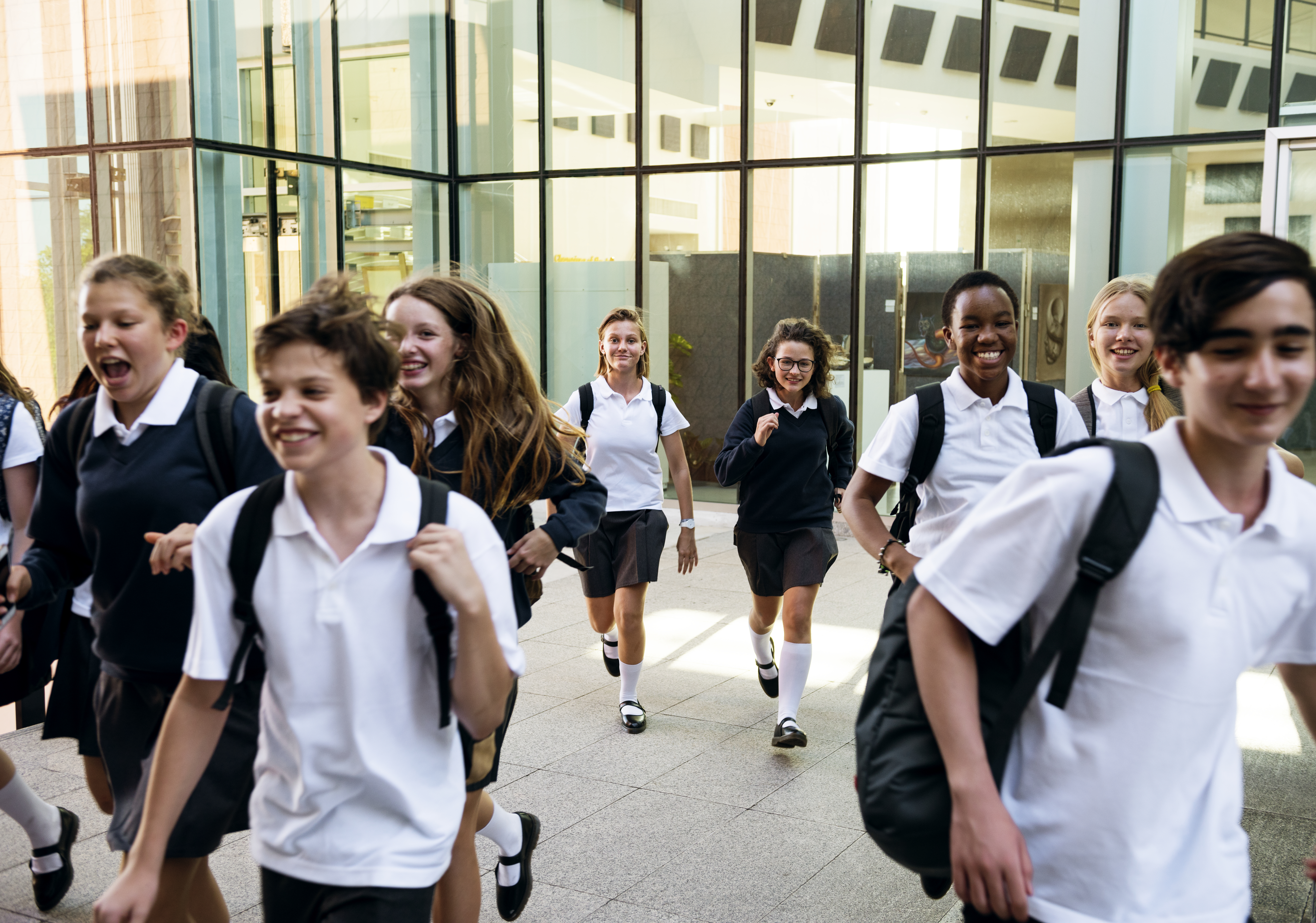 Group of students running at school