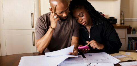 man and woman surrounded by bills