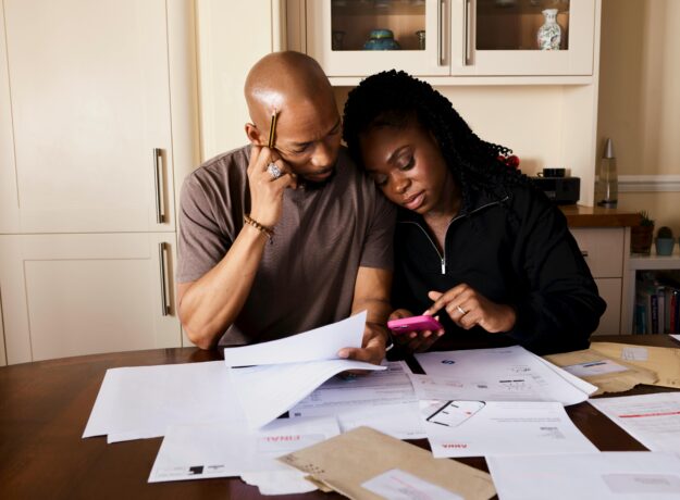 man and woman surrounded by bills